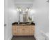 Bathroom boasts a granite vanity, tiled floors, large mirror and modern lighting at 7912 Baltusrol Ln, Charlotte, NC 28210