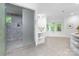 Luxurious bathroom featuring a glass-enclosed shower, soaking tub, and ample natural light at 7912 Baltusrol Ln, Charlotte, NC 28210