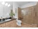 Bathroom features a glass enclosed shower, vanity, granite counters, and tile flooring at 7912 Baltusrol Ln, Charlotte, NC 28210