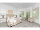 Bedroom offers neutral carpet, natural light and sitting area with furniture at 7912 Baltusrol Ln, Charlotte, NC 28210