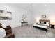 Bedroom with neutral walls features sitting area, and console table at 7912 Baltusrol Ln, Charlotte, NC 28210