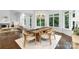 Sunlit dining room with hardwood floors and views of the surrounding greenery at 7912 Baltusrol Ln, Charlotte, NC 28210