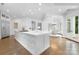Open concept kitchen showcasing a large island, modern appliances, and hardwood floors at 7912 Baltusrol Ln, Charlotte, NC 28210