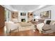 Bright living room features a fireplace, hardwood floors, built-in shelving and neutral colors at 7912 Baltusrol Ln, Charlotte, NC 28210