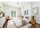 Bright bedroom features hardwood floors, large windows, white furniture and modern decor at 7912 Baltusrol Ln, Charlotte, NC 28210
