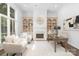 Bright home office featuring built-in bookshelves and a cozy fireplace at 7912 Baltusrol Ln, Charlotte, NC 28210