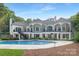 Expansive rear view of home featuring a pristine swimming pool and landscaped backyard, perfect for outdoor living at 7912 Baltusrol Ln, Charlotte, NC 28210