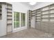 Spacious walk-in closet with custom shelves, drawers and window providing natural light at 7912 Baltusrol Ln, Charlotte, NC 28210