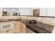 A wet bar boasts granite counters, microwave, small refrigerator, and backsplash tile at 7912 Baltusrol Ln, Charlotte, NC 28210