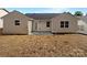Exterior back view of the home, featuring a small patio and a freshly prepared yard at 8219 Pozzi Rd, Charlotte, NC 28216
