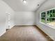 Comfortable bedroom space with plush carpeting, natural light, and serene view at 8219 Pozzi Rd, Charlotte, NC 28216