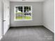 Well-lit bedroom with a large window and neutral carpet at 8219 Pozzi Rd, Charlotte, NC 28216