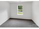 Cozy bedroom with a large window and neutral carpet at 8219 Pozzi Rd, Charlotte, NC 28216