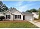Charming single-story home featuring light siding, black shutters, and an attached one-car garage at 8219 Pozzi Rd, Charlotte, NC 28216