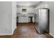 Well-lit kitchen featuring white cabinets, stainless steel appliances and wood-look flooring at 8219 Pozzi Rd, Charlotte, NC 28216