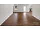 Open-concept living area with wood-look flooring, bright natural light, and a view into the kitchen at 8219 Pozzi Rd, Charlotte, NC 28216