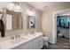 Bright bathroom with double sinks, mirrors, and walk-in closet at 8310 Brickle Ln, Huntersville, NC 28078