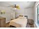Comfortable bedroom featuring a ceiling fan, wood floor, and bright window at 8310 Brickle Ln, Huntersville, NC 28078