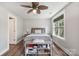 Comfortable bedroom with ceiling fan, window, and wood-look flooring at 8310 Brickle Ln, Huntersville, NC 28078