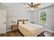 Comfortable bedroom featuring a ceiling fan, wood floor and bright window at 8310 Brickle Ln, Huntersville, NC 28078
