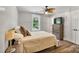 Comfortable bedroom with a ceiling fan, wood floor and bright window at 8310 Brickle Ln, Huntersville, NC 28078