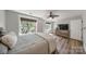 Well-lit bedroom featuring wood-look floors, ceiling fan, and large windows at 8310 Brickle Ln, Huntersville, NC 28078