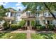Inviting townhome featuring well-manicured landscaping, front porch, and charming curb appeal at 8310 Brickle Ln, Huntersville, NC 28078