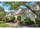 Charming townhome with a well-maintained exterior, front porch, and mature trees at 8310 Brickle Ln, Huntersville, NC 28078
