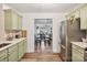 Bright kitchen with stainless steel appliances, view to dining space, and herringbone backsplash at 8310 Brickle Ln, Huntersville, NC 28078
