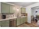 Cozy kitchen featuring stainless steel appliances, herringbone backsplash and a sink at 8310 Brickle Ln, Huntersville, NC 28078