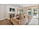 Inviting living room with a fireplace, plush seating, and natural light from large windows at 8310 Brickle Ln, Huntersville, NC 28078