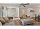 Bright and airy living room with hardwood floors, plush seating, and access to dining area at 8310 Brickle Ln, Huntersville, NC 28078