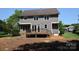Backyard with mature trees, deck, and sliding glass doors at 9228 Old Barnette Pl, Huntersville, NC 28078