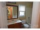Secondary bathroom boasts a vanity with a solid surface countertop and a tub with tile surround at 9228 Old Barnette Pl, Huntersville, NC 28078