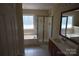 Bright bathroom features a large soaking tub, walk-in shower, and vanity with cherry-stained cabinets at 9228 Old Barnette Pl, Huntersville, NC 28078