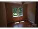 Cozy bedroom filled with natural light, thanks to the large windows overlooking mature trees at 9228 Old Barnette Pl, Huntersville, NC 28078