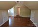 Large bonus room with hardwood flooring, built in shelves, and ample storage space at 9228 Old Barnette Pl, Huntersville, NC 28078