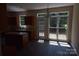 Bright kitchen space with center island, a door with access to an outdoor deck, and hardwood floors at 9228 Old Barnette Pl, Huntersville, NC 28078