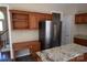 Kitchen space with desk and stainless steel refrigerator at 9228 Old Barnette Pl, Huntersville, NC 28078
