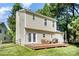 A well-maintained home backyard features a wood deck with outdoor seating and a grill at 9808 Steed Ct, Charlotte, NC 28269