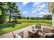 Inviting backyard deck featuring stylish outdoor furniture, beautiful lawn, and a scenic view at 9808 Steed Ct, Charlotte, NC 28269