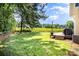 Expansive backyard with a wood privacy fence and a deck with a grill and outdoor seating at 9808 Steed Ct, Charlotte, NC 28269