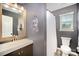 Cozy bathroom featuring a stylish mirror, vanity, toilet, and shower with patterned curtain at 9808 Steed Ct, Charlotte, NC 28269