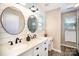 Well-lit bathroom showcasing a double vanity, shiplap accent wall, and stylish fixtures for a modern touch at 9808 Steed Ct, Charlotte, NC 28269