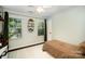Cozy bedroom featuring hardwood floors, two windows with wooden blinds and a modern ceiling fan at 9808 Steed Ct, Charlotte, NC 28269