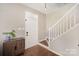 Bright entryway with hardwood floors, white trim, and staircase at 9808 Steed Ct, Charlotte, NC 28269