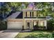 Charming two-story home featuring a well-maintained lawn, garage, and inviting front porch framed by mature trees at 9808 Steed Ct, Charlotte, NC 28269
