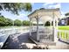 Charming lakeside gazebo with white railings and seating, offering a relaxing waterfront view at 9808 Steed Ct, Charlotte, NC 28269