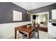 Eat-in kitchen with a wooden table and view into a living room with fireplace at 9808 Steed Ct, Charlotte, NC 28269