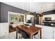 Modern kitchen with stainless steel appliances, granite countertops, white cabinets, and an open view to living room at 9808 Steed Ct, Charlotte, NC 28269